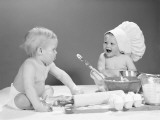 Two Babies With Mixing Bowls and Rolling Pins  One Wearing Chef's Hat  Flour on Faces
