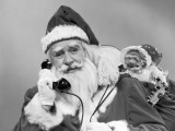 Santa Claus on the Telephone With His Sack of Toys on His Back