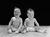 Twin Babies Sitting Wearing Diapers  Laughing and Smiling