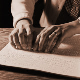 Woman's Hands Reading Braille