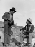 Two Cowboys at Campsite  One Standing  Pouring Coffee