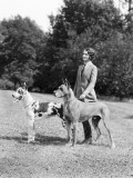 Young Woman  Two Great Dane Dogs on a Leash