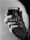 Hand Holding Full Shot Glass  Close-Up