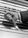 Man Pulling Lever of Voting Machine