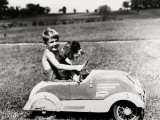 Boy Driving Toy Car  With Springer Spaniel Dog in His Lap