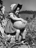 Girl Sitting on Pumpkin  Wearing Sun Bonnet