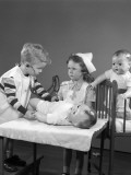 Boy and Girl Playing Doctor and Nurse Using Doll As a Patient