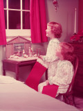Twin Girls Holding Christmas Stockings  Looking Out of Bedroom Window
