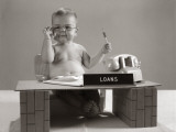 Baby at Desk Playing Loan Officer