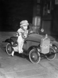 Girl in Toy Pedal Car With Dog Sitting on Running Board