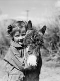 Girl Wearing Striped Overalls  Hugging Burro Donkey
