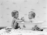 Baby Boy Sittings in Wash Tub  Washing Feet of Girl Sitting Outside of Tub