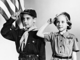 Boy and Girl Scouts Saluting  American Flag in Background