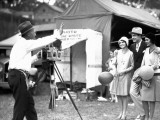 Man With Arms Around Two Women  Holding Balloons  Getting Picture Taken at County Fair