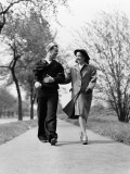 Couple Walking Outdoors  Man Wearing Sailor Uniform  Woman Wearing Coat  Hat and Gloves