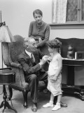 Male Doctor Making House Call  Holding Stethoscope To Chest of Little Boy Patient
