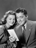 Smiling Couple Looking at Brochure