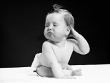 Baby With Hand on Ear