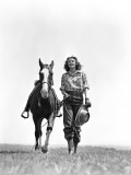 Woman Walking Beside Horse Holding Cowboy Hat in Gloved Hand
