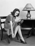 Woman Sitting in Chair  Rubbing Her Feet