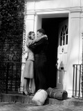 Sailor With Duffel Bags  Hugging Woman  About To Kiss on Front Doorstep
