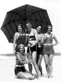 Four Women and One Man Under Beach Umbrella in Bathing Suits