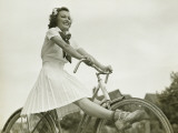 Young Woman Riding on Bicycle With Outstretched Legs
