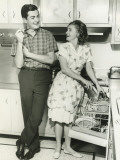 Young Couple Standing in Kitchen  Woman at Dishwasher
