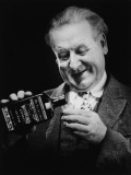 Senior Man Pouring Whiskey From Bottle To Glass