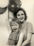 Smiling Mother and Daughter With Balloons