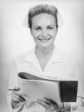 Nurse Holding Medical Chart in Studio  Portrait