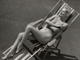 Nude Woman Sunbathing in Beach Chair