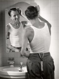 Man in Undershirt Grooming Hair in Bathroom Mirror