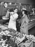 Store Clerk Weighing Tomatoes For Client