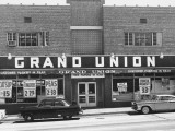 Cars Parked on Town Street  in Front of Shop