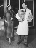 Grocery Store Clerk Carrying Packages For Elegant Woman