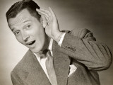 Businessman Cupping Ear To Hear