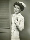 Young Nurse Smiling By Open Door
