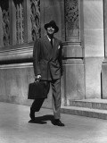 Man in Full Suit Walking on Sidewalk