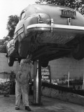 Mechanic Working on Underside of Car