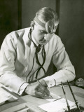 Doctor Writes at His Desk
