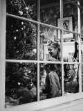 Boy and Girl (3-8) Looking at Christmas Tree