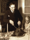 Father Carving Turkey at Table on Christmas Day