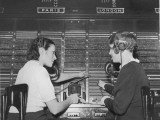 Two Female Switchboard Operators Connecting International Calls