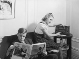 Boy and Girl (12-15) at Home Reading and Listening To Radio