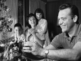 Family in Living Room  Father Decorating Christmas Tree