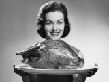 Woman Holding Platter With Roast Turkey