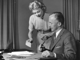 Woman Showing Man Cheque  Man Holding Pen