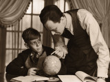 Father Helping Son With Geography Homework