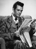 Man Sitting in Armchair  Reading Newspaper